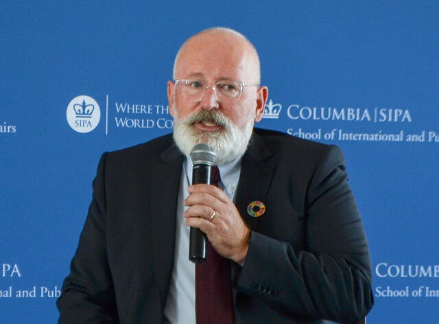 Frans Timmermans is a middle-aged white man, mostly bald, with a gray-white beard and mustache.