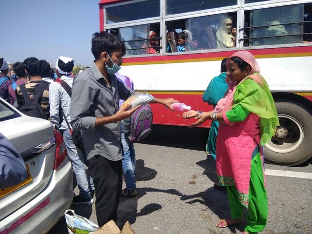 Volunteers in India distribute hand sanitizer and food to migrant workers. Photo: Muhammad Wajihulla